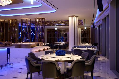 a dining room with a table and chairs at Grand Hyatt Jeju in Jeju