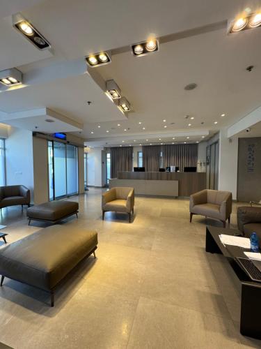 a lobby with couches and a waiting room at Abratel Sea View in Tel Aviv