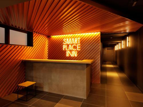 a smart place run sign on the wall of a building at Smart Place Inn Kyoto Shijo Omiya East in Kyoto