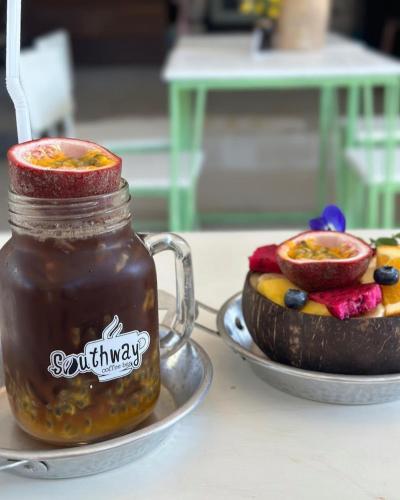 a jar of honey next to a bowl of fruit at Southwayhome in Koh Phangan
