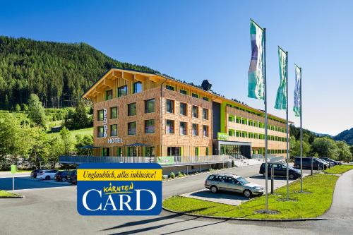 a building with a car parked in front of it at Explorer Hotel Bad Kleinkirchheim in Bad Kleinkirchheim