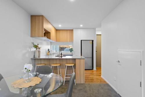 a kitchen with a table and chairs and a counter at Cosy Oasis Close To CBD in Christchurch