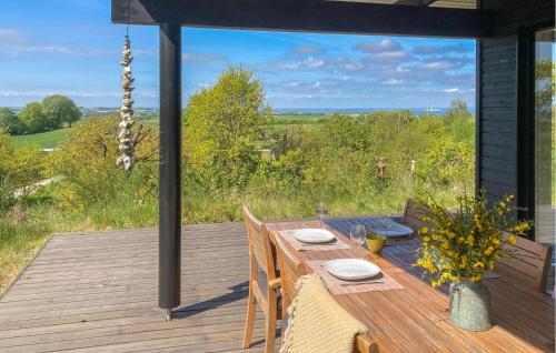 a wooden table on a deck with a view at Nice Home In Knebel With House Sea View in Knebel