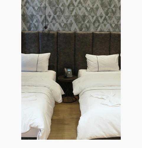 Postel nebo postele na pokoji v ubytování StarLight Hotel