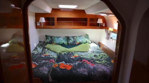a small room with a bed in the back of a train at ALL ONE Catamaran in Ponta Delgada
