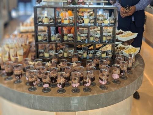 a display of cupcakes and other desserts on a table at Vivanta Bhubaneswar DN Square in Bhubaneshwar