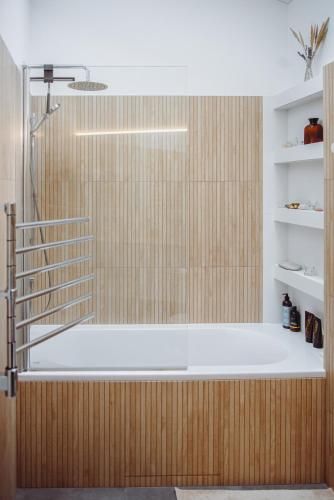 a bath tub in a bathroom with a shower at Oak Zen Home in Birštonas