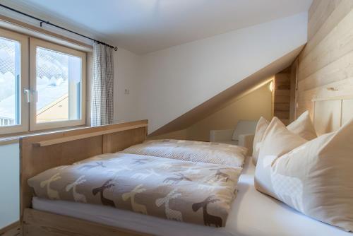 a bedroom with a bed and a window at Appartement Moosmann in Mellau