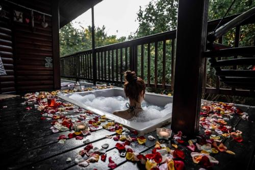 a dog sitting in a bath tub filled with debris at Thulamela Couples Retreat in Hazyview