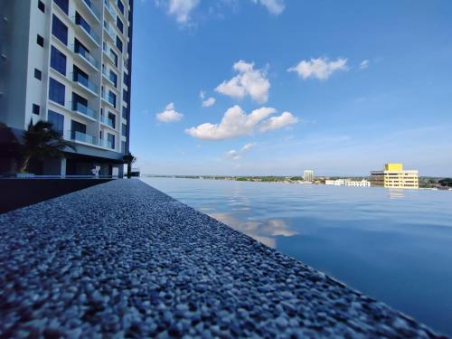a view of a body of water between two buildings at Sunny Bear Suites, Alor Setar in Alor Setar