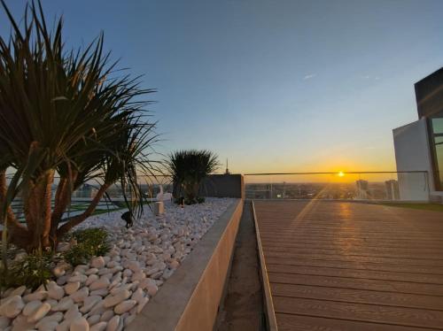 a walkway with palm trees on top of a building at Sunny Bear Suites, Alor Setar in Alor Setar