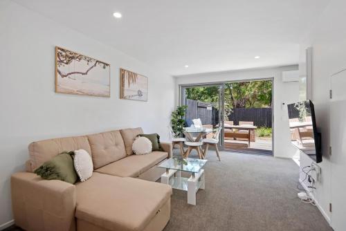 a living room with a couch and a table at 5 Minute Walk to Arena & Stadium in Christchurch