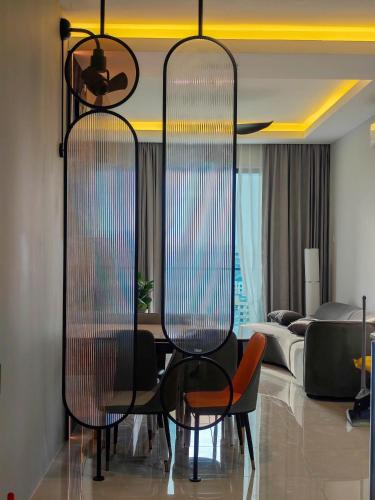 a living room with two chairs and a table at Sunny Bear Suites, Alor Setar in Alor Setar