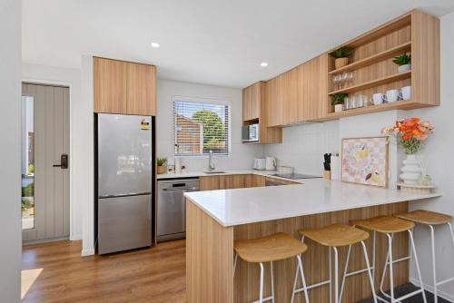 a kitchen with a counter and a refrigerator at 5 Minute Walk to Arena & Stadium in Christchurch