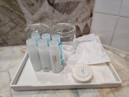 a tray with glass bottles on top of a counter at First Pacific Cirrus in Pattaya Central