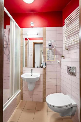 a bathroom with a toilet and a sink at Great Polonia Dwarf Wrocław in Wrocław