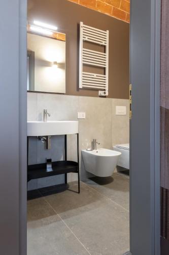 a bathroom with a sink and a tub and a toilet at Borgo Bucciano in San Miniato