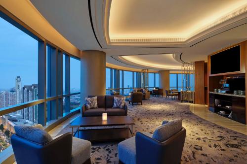 a living room with a view of a city at The Westin Surabaya in Surabaya
