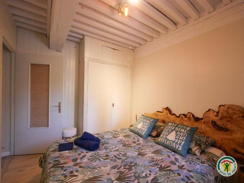 a bedroom with a bed with a large wooden headboard at "La bâtisse des prés" in Puy-Saint-Vincent