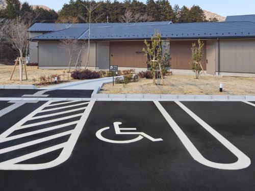 a parking lot with a handicapped sign in front of a building at Rakuten STAY Hakone Susuki Grass Fields in Sengokuhara