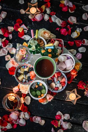 a table topped with lots of dishes of food at Thulamela Couples Retreat in Hazyview