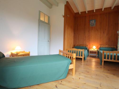 a room with two beds and two chairs in it at Gîte de charme 10 pers. à Saint-Vert - Nature préservée, 4 chambres, jardin clos - FR-1-582-307 in Saint-Vert
