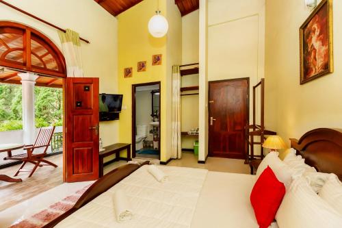 a bedroom with a bed and a living room at Ella Heaven Inn in Kumbalwela