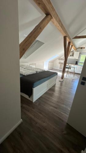 a bedroom with a bed and a wooden floor at Schönes Appartement mit Seeblick in Gummersbach