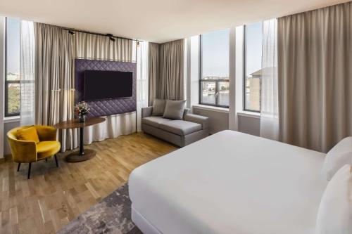 a hotel room with a bed and a television at NH Collection Copenhagen in Copenhagen