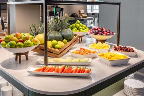 a buffet of fruits and vegetables on a table at NH Collection Copenhagen in Copenhagen