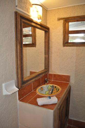 a bathroom with a sink and a mirror at Rossco Hostel & Hotel in San Cristóbal de Las Casas
