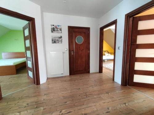an empty room with two doors and a bedroom at Na Brzegu in Krempachy