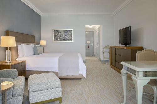 a hotel room with a bed and a television at Kempinski Hotel Cancun in Cancún
