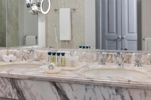 two sinks in a bathroom with a large mirror at Kempinski Hotel Cancun in Cancún