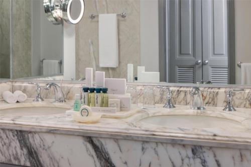 two sinks in a bathroom with a large mirror at Kempinski Hotel Cancun in Cancún