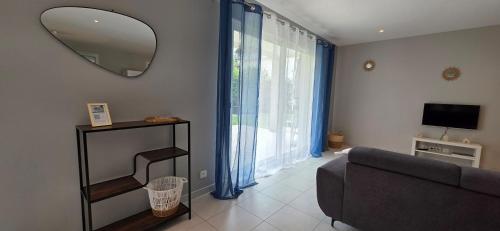 a living room with a couch and a mirror at Les dentelles Évasion Provençale Villa avec Piscine et jardin in Carpentras