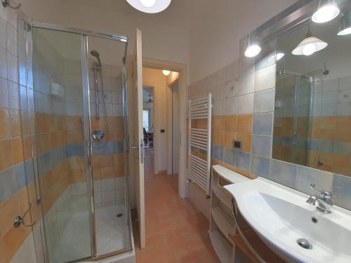 a bathroom with a glass shower and a sink at STEFY - Fondi Vertice Houses in Lido Di Fondi