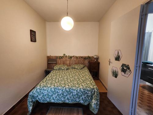 a bedroom with a bed with a comforter at Dolphin's House in Avignon