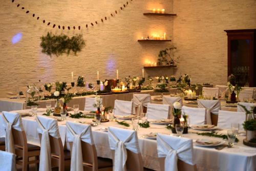 a banquet hall with white tables and white chairs at Hotel EUROPA - Górnicza Strzecha in Szklarska Poręba