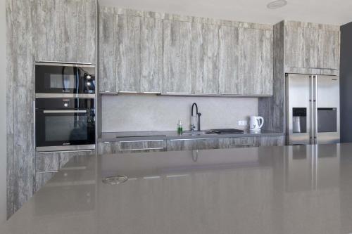 a kitchen with stainless steel appliances and a counter top at The Stables in Arona