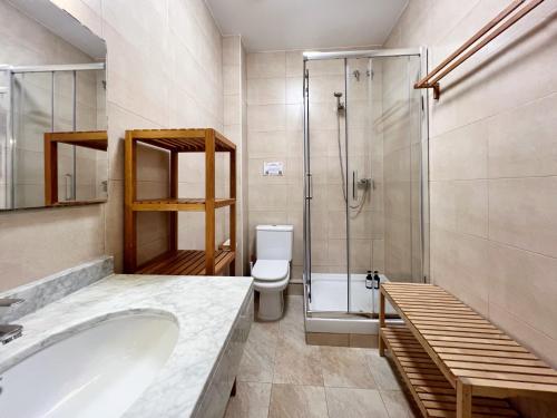 a bathroom with a tub and a shower and a toilet at Torre de Gracia Barcelona in Barcelona