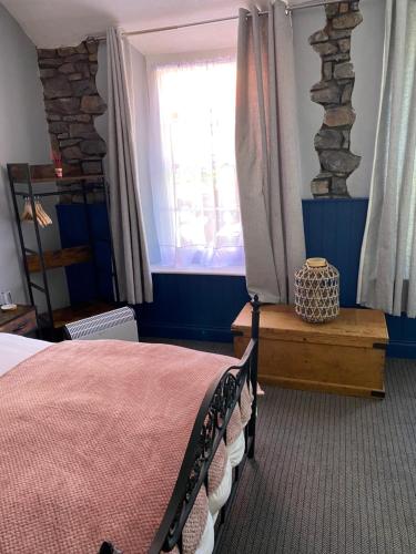 a bedroom with a bed and a window at The Kings Head in Cheddar