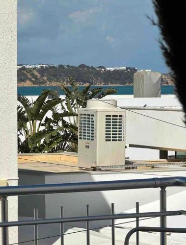 a air conditioner sitting on top of a balcony at Sea View Appartement a la Marsa plage in Douar el Hafey