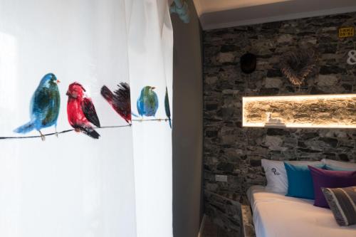 a room with paintings of birds on the wall at Y Palmela - Boutique Apartments in Palmela