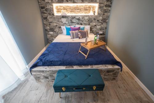 a bedroom with a large bed with a table on it at Y Palmela - Boutique Apartments in Palmela