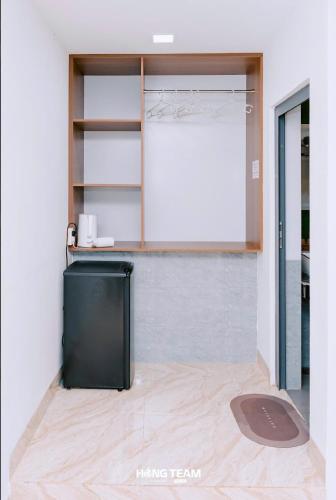 a room with a black refrigerator in a room at Lá Giang Garden BMT in Buon Ma Thuot