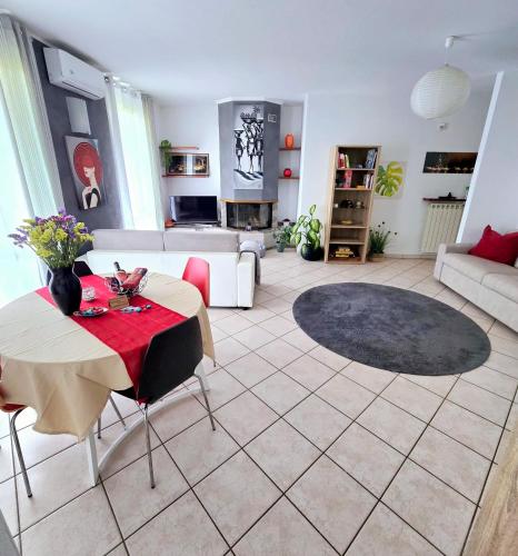 a living room with a table and a couch at ZARA HOUSE - Lake and Pet Friendly in Brusimpiano