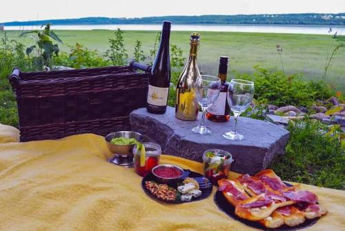 a table with two bottles of wine and a plate of food at Studio 11 - 2 min du Bord de l'eau Foyer & Barbecue in Sainte-Anne-de-Beaupré