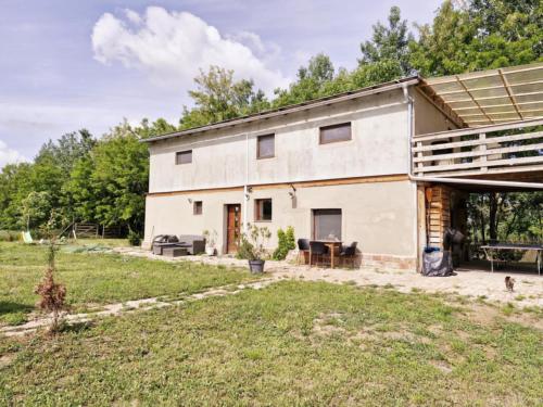 a white building with a porch and a yard at Hacienda Verde in Szentes