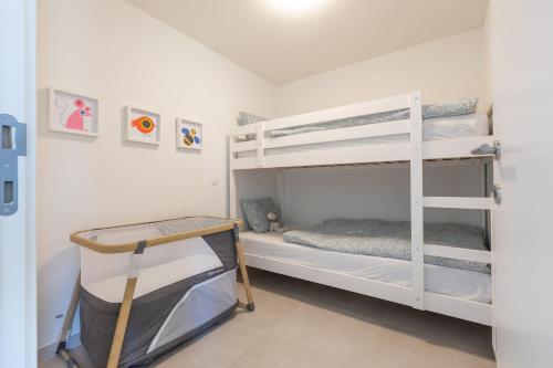 a bedroom with two bunk beds in a room at LECOMTE - The Shoreline Green 153 in Ostend